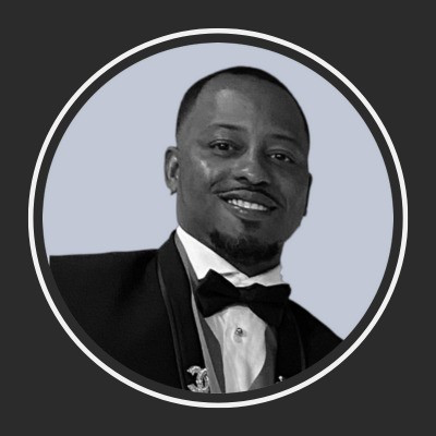 Black-and-white portrait of Matthew Kemp in a tuxedo and bow tie, smiling